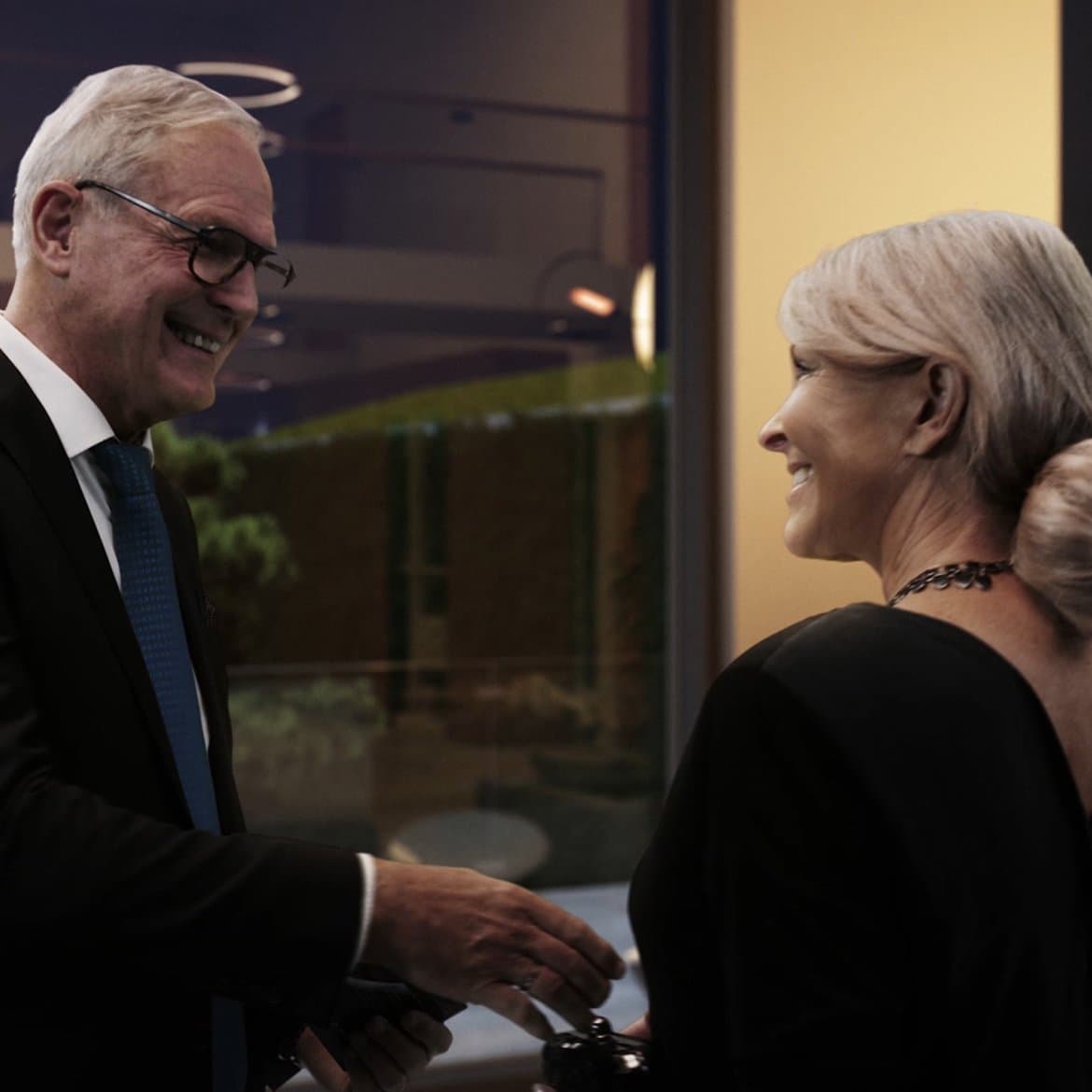 Elegant couple smiling at one another